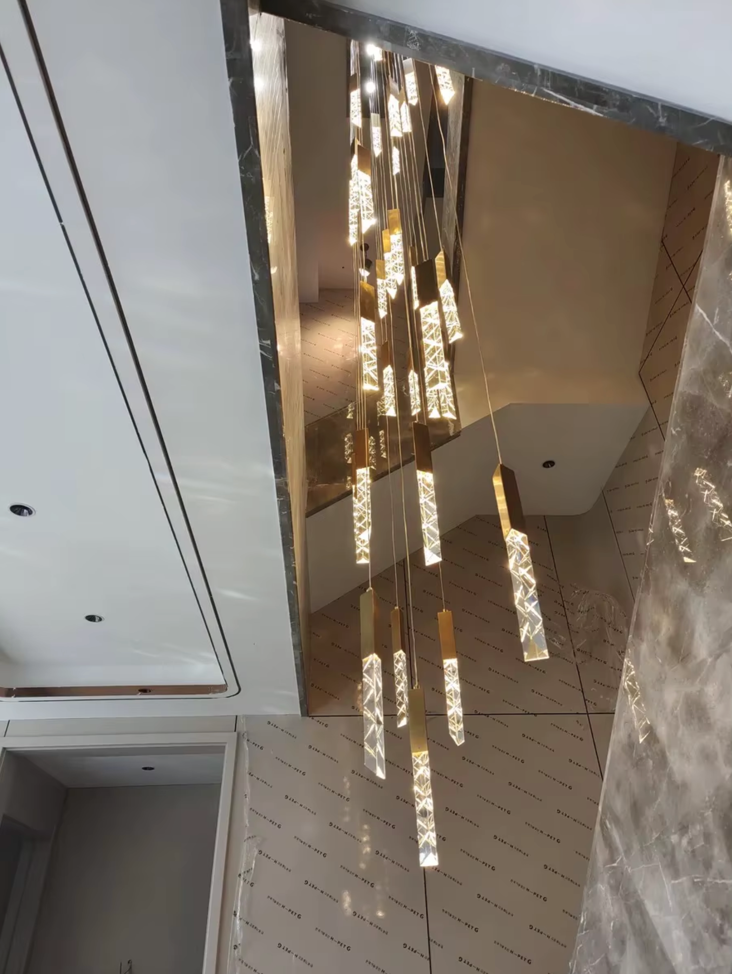 cluster gold led pendants on staircase