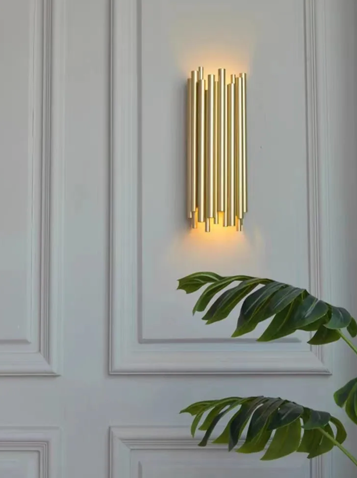 Gold tubed wall light