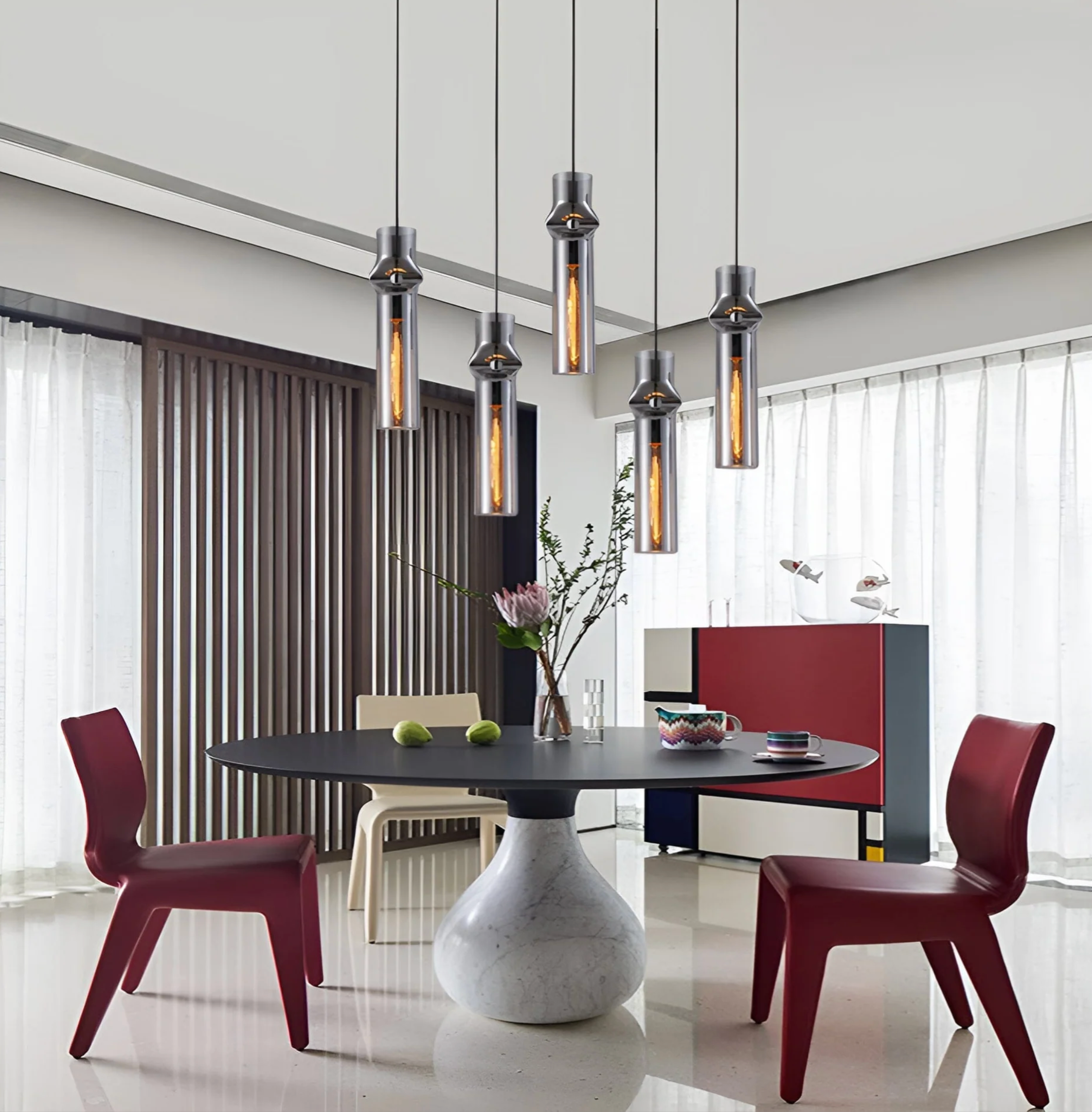 cylindrical pendant lights hanging over table