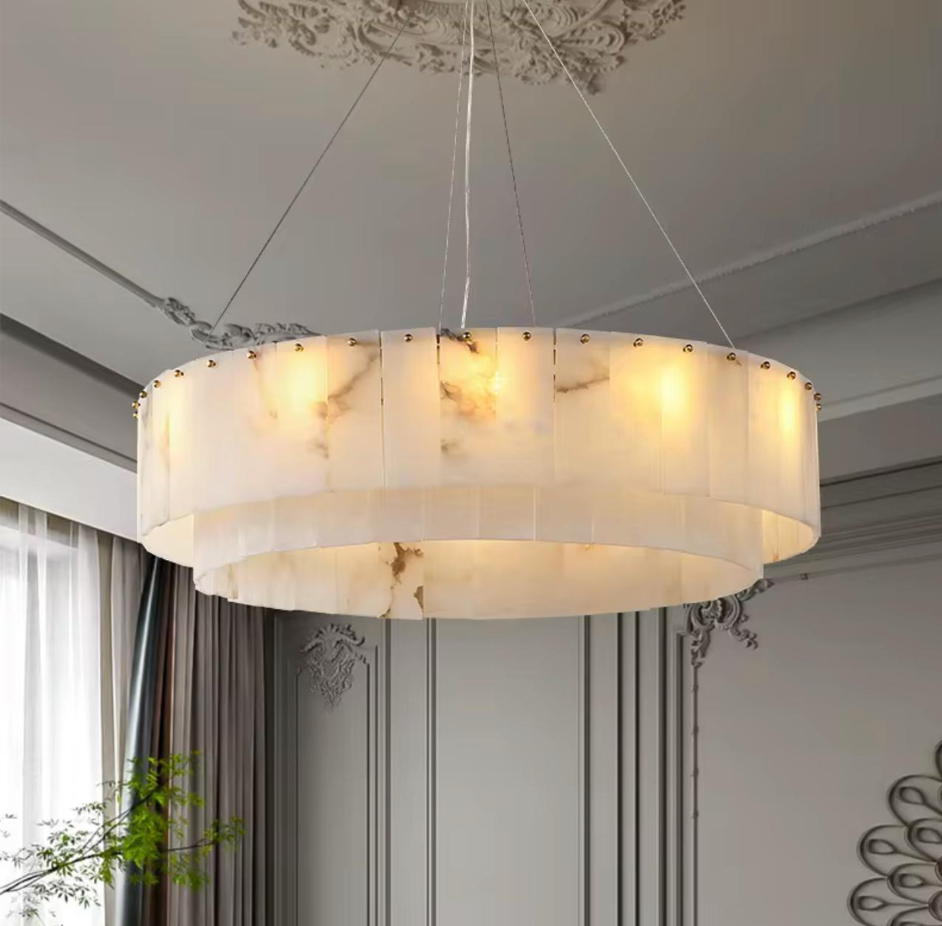 Decorative ceiling light fixture in a room with curtains and wall decor.