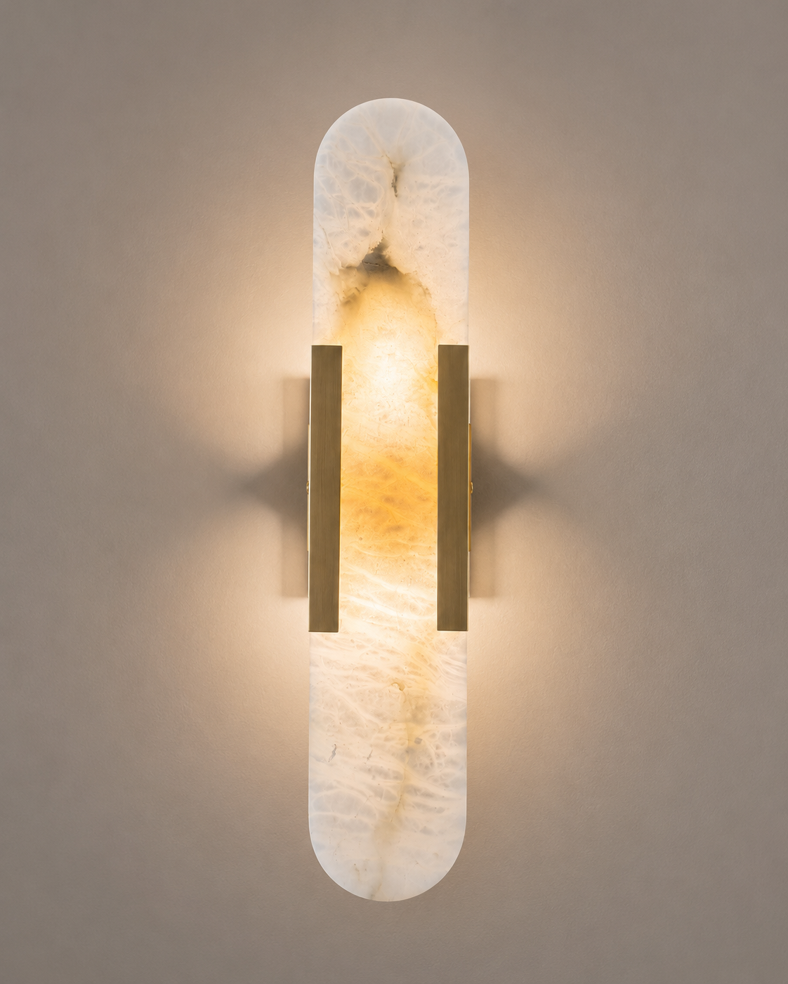Wall-mounted light fixture with marble-like design and gold accents on a neutral background