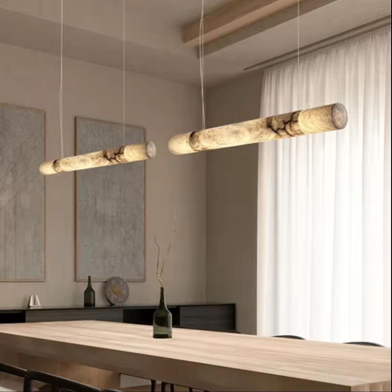 Modern pendant lights hanging above a dining table in a stylish room.