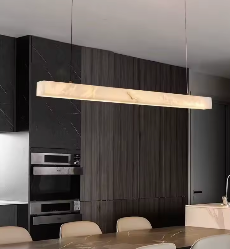 Modern kitchen with a long rectangular pendant light fixture.