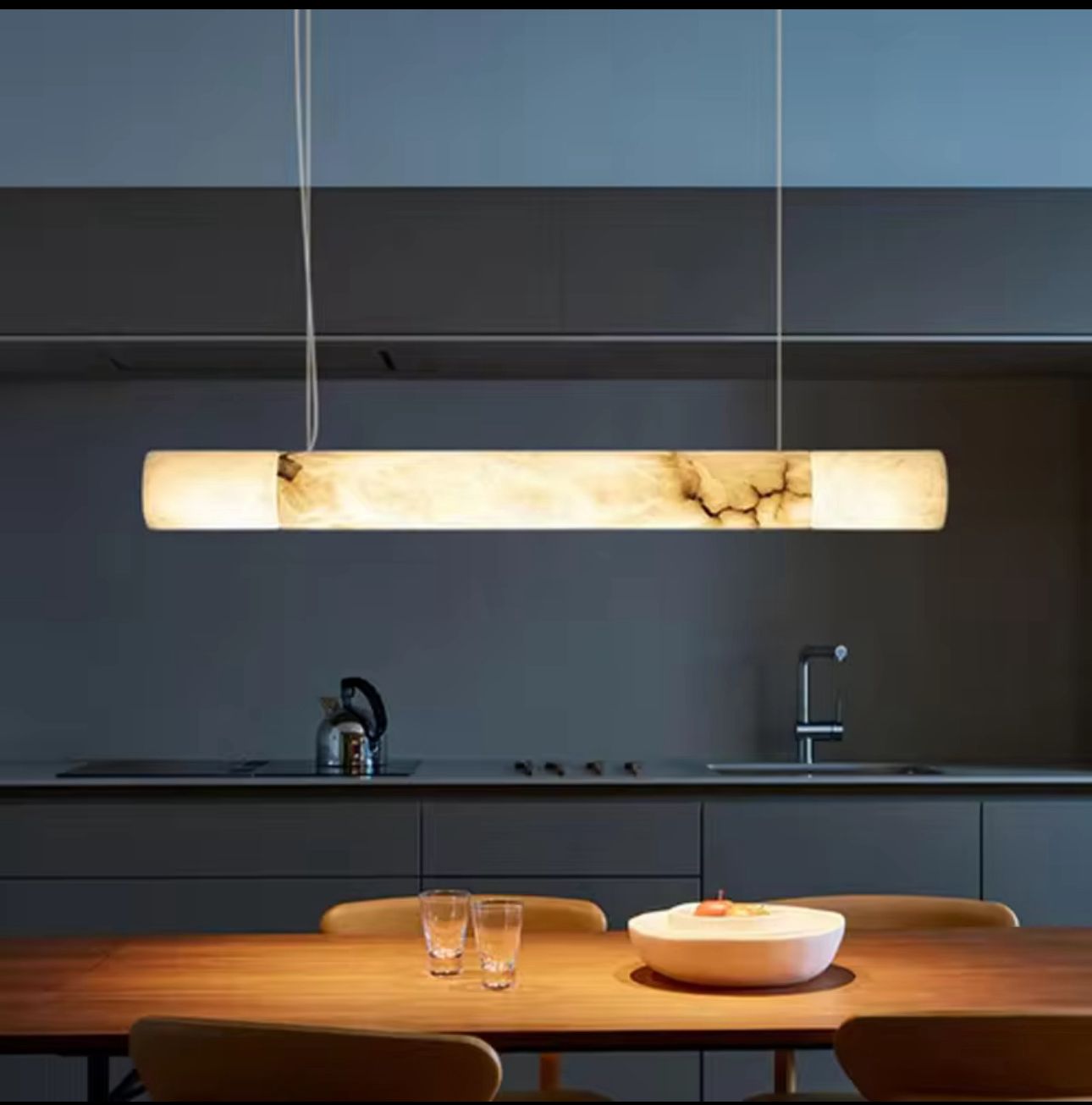 Modern kitchen with a long rectangular pendant light fixture.