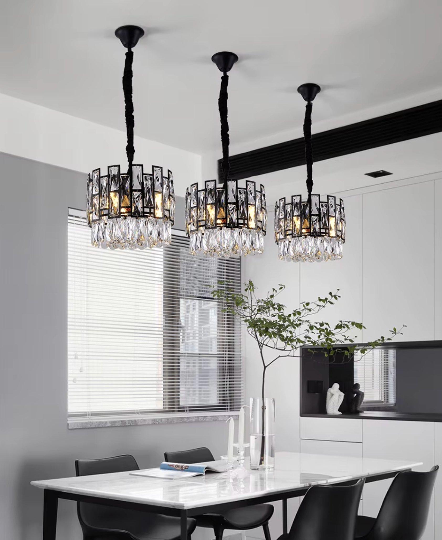 3 small crystal chandeliers hanging over dining table