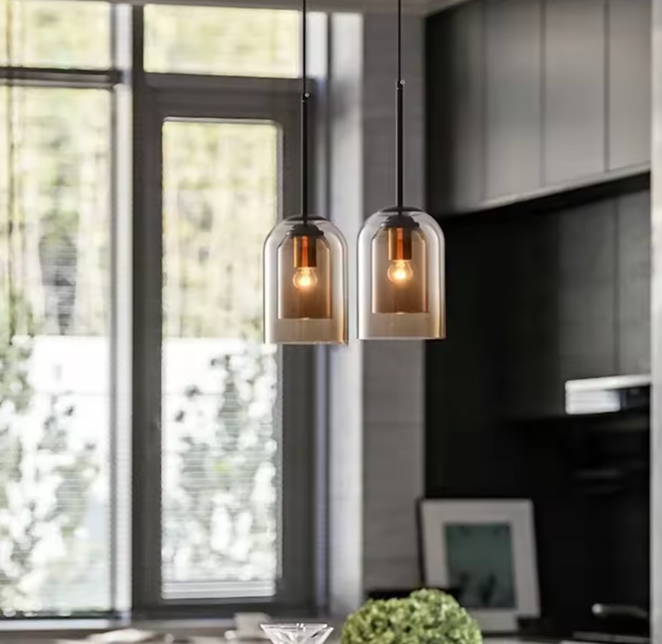 2 amber smoked glass pendant lights over table 